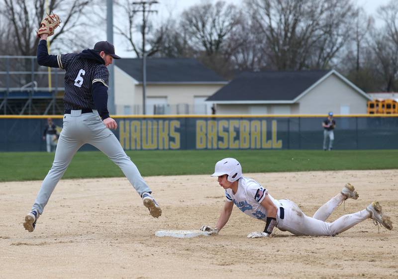 Parkview Christian Academy's James Jefferson slides in safely with a triple as Hiawatha's Aidan Cooper takes the throw Thursday, April 17, 2025, during their game at Hiawatha High School in Kirkland.