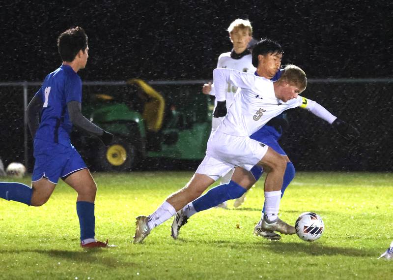 Sycamore's Aiden Sears pushes the ball ahead of a pair of Burlington Central players Tuesday, Oct. 21, 2025, during their IHSA Class 2A regional semifinal match at Burlington Central High School.