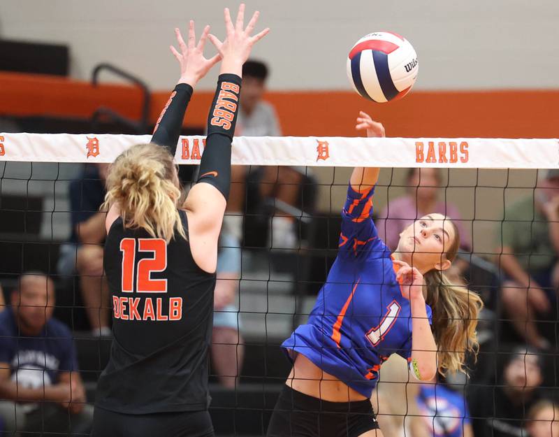 Genoa-Kingston's Presley Meyer tries to spike the ball by DeKalb's Isabelle Smith during their match Wednesday, Sept. 10, 2025, at DeKalb High School.