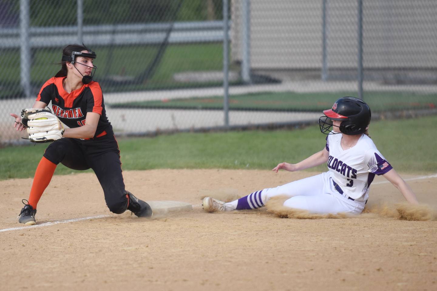 Beecher's Grace Wuest, left, looks to apply a tag on Wilmington's Nina Egizio as Egizio slides in with a stolen base during a game at Wilmington Thursday, April 23, 2026.