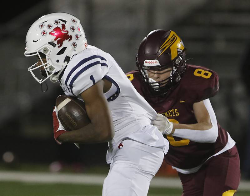 St. Viator's Dayvion Ellis tries to get out of the trap of Richmond-Burton's Jack Martens during a IHSA Class 4A first round playoff football game Friday, Oct. 27, 2023, at Richmond-Burton High School in Richmond.