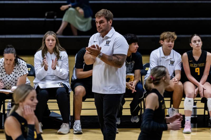 Joliet West varsity volleyball coach Chris Lincoln applauds the team during a home game against Lincoln-Way West on Sept. 15, 2025.