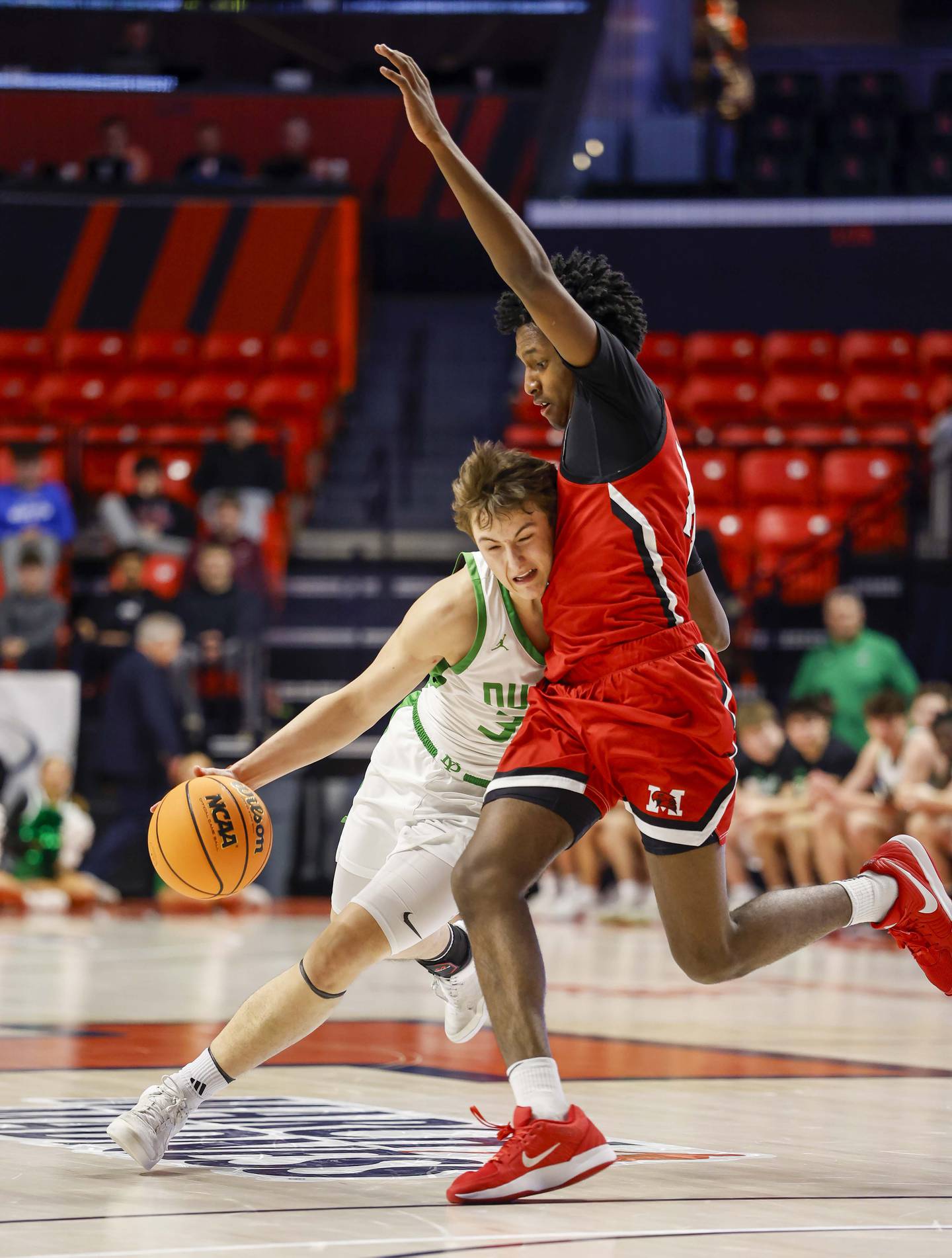 York’s Will O'Leary (30) tries to muscle his way past Marist's Charles Barnes Jr. (14) during the IHSA Class 4A boys basketball state semifinal Friday, March 13, 2026 at the State Farm Center in Champaign.