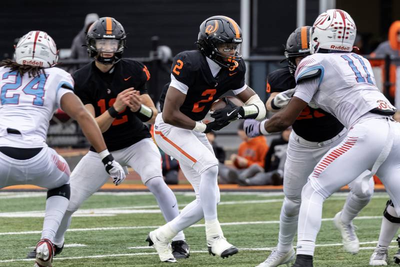 Lincoln-Way West's Jahan Abubakar looks for an opening during a 7A varsity football playoff game against Kenwood at Lincoln-Way West on Nov. 8, 2025.