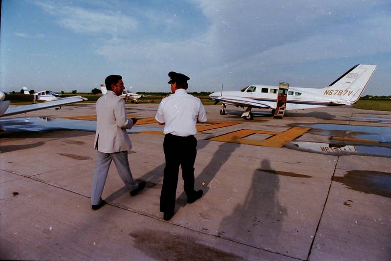 Pilots walk to their planes during the summer of 1986 at the Illinois Valley Regional Airport in Peru.