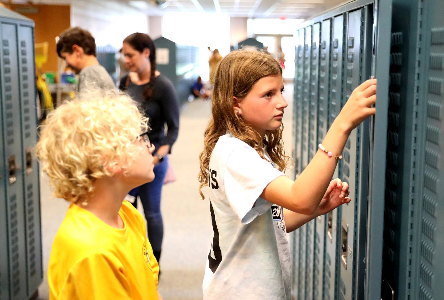 Geneva Middle School South seventh-grader Lyla Clemons organizes her locker as her sixth-grade brother, Finn Clemons, looks on during a supply drop-off session at the school on Thursday, Aug. 10, 2023.