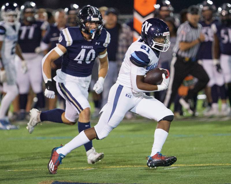 Nazareth's Lesroy Tittle runs the ball for a gain against IC Catholic on Friday, Sept.15,2023 in Elmhurst.