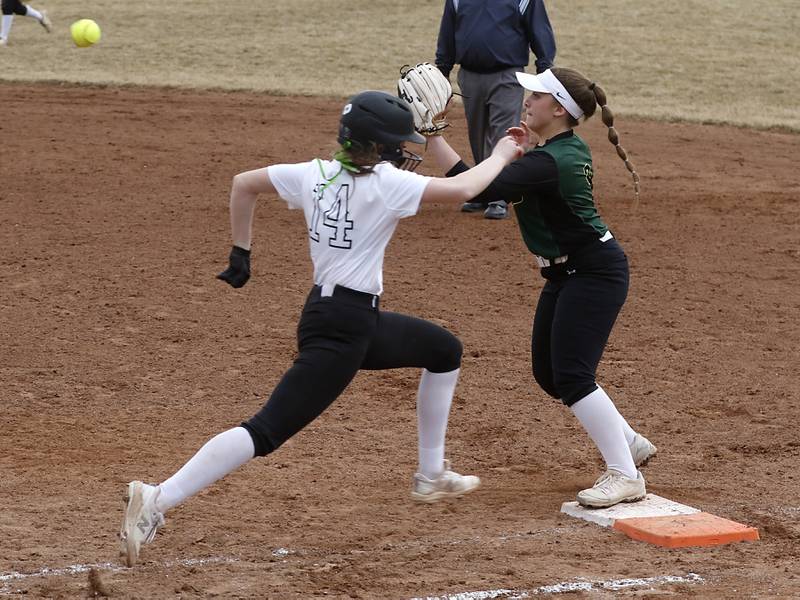 Huntley’s Madison Rozanski tries to bet out the throw to Fremd’s Chiara D'Antonio as he runs to first base during a non-conference softball game Thursday March 17, 2022, between Huntley and Fremd at Huntley High School.