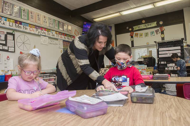 Jefferson School kindergarten teacher Melissa Heaton helps a student with his school work Thursday, April 7, 2022 at the school.