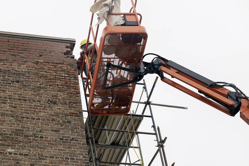 A masonry worker tuck points the roof of The Dixon: Historic Theatre on Monday, Nov. 25, 2024. A renovation of the historic Dixon building is well underway.