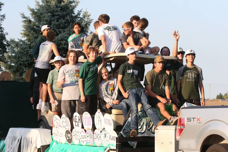 Members of the St. Bede boys and girls golf teams ride in the St. Bede Homecoming Parade on Friday, Sept. 29, 2023 at St. Bede Lane.