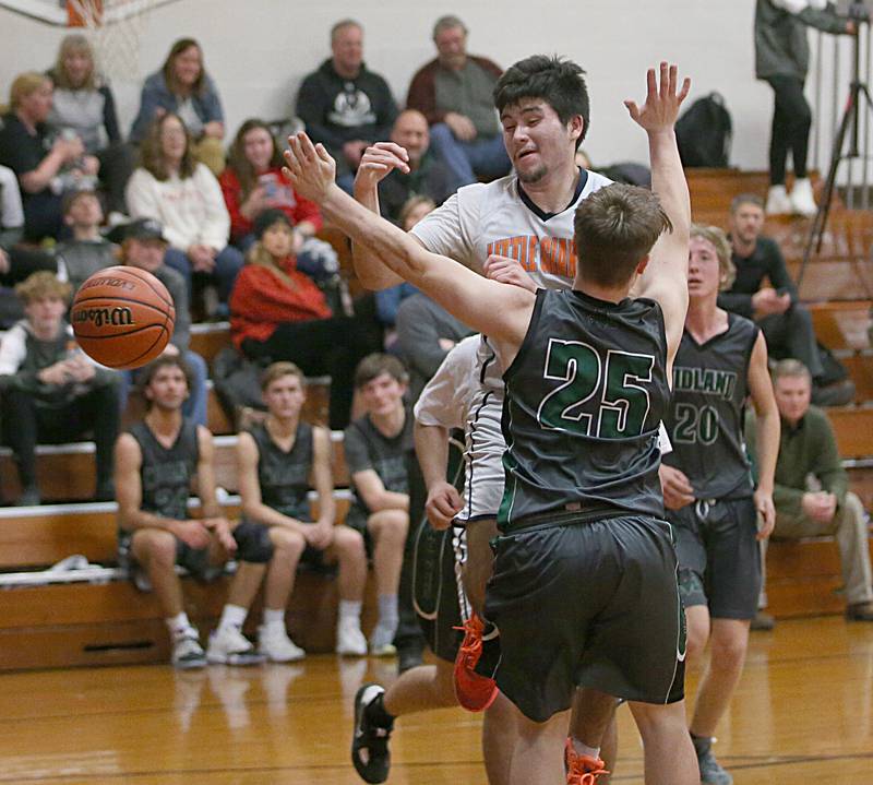 Depue's Oscar Lopez (top) looses control of the ball in the lane as Midland's Trevin Mienders defends on Monday, Dec. 19, 2022 at DePue High School.