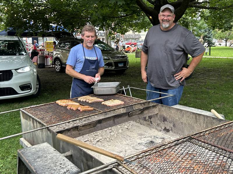 Rick Nelson and Eric Bocker of the Ogle County Pork Producers were busy grilling for the Rock River Center food booth at  the  Jamboree concert on Friday, Aug. 15, 2025 in downtown Mt. Morris.