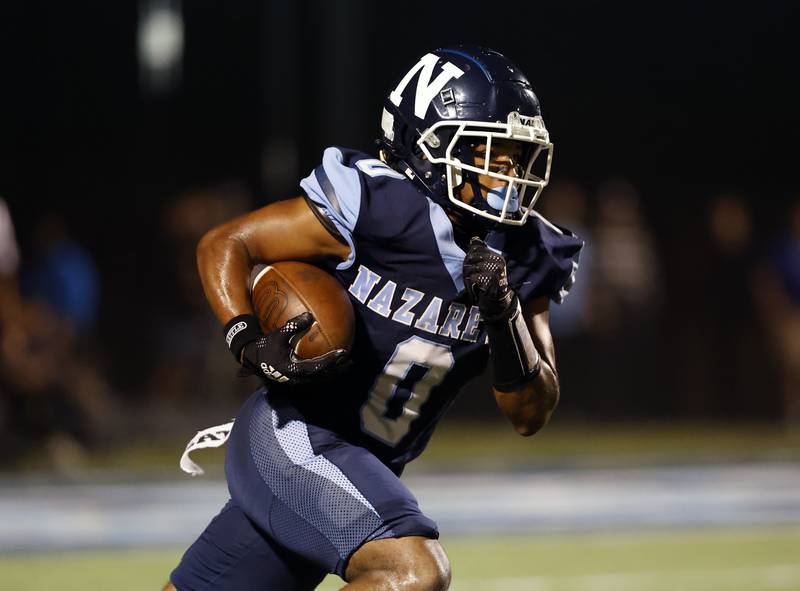 Nazareth's Edward McClain Jr. (0) runs during the varsity football game between Mt. Carmel high school and Nazareth Academy on Friday, Sept. 12, 2025 in La Grange Park, IL.
