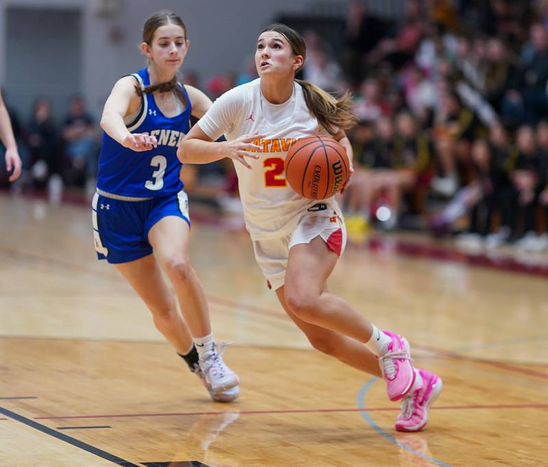 Batavia's Brooke Carlson (2) drives to the basket against Geneva’s Hope Ieler (3) during a basketball game at Batavia High School on Friday, Jan 26, 2024.