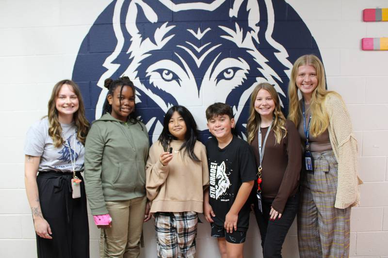 Wesmere Elementary School speech-language pathologist Megan Eberle, fifth graders Londyn Robinson, Olivia Marcos and Hayden Castro, and fifth-grade teachers Ashley Richard and Clara Davidson worked on the inaugural Wolf Pack Podcast released in October 2025.