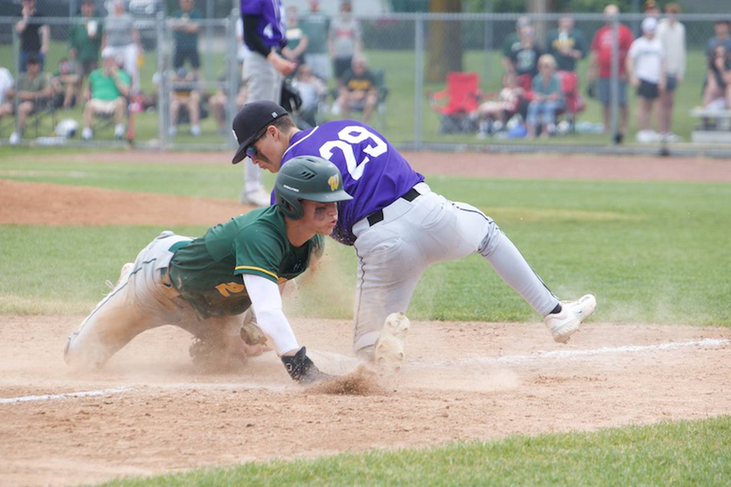 Waubonsie's Owen Roberts sides into third before the tag by Downers Grove North's Antonio Russotiesi at the Class 4A Sectional Final on Saturday, June 7, 2025 in Lockport.