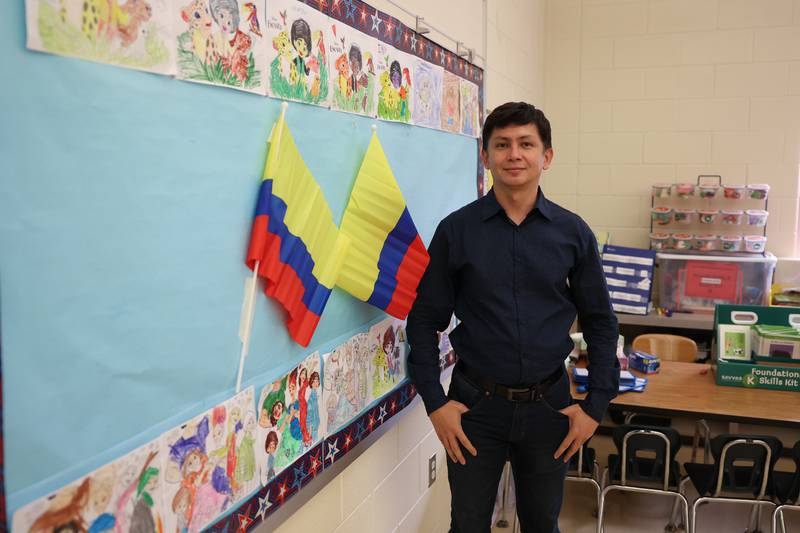 Augusto Quiroz-Cardenas of Colombia, a bilingual kindergarten class at Sator Sanchez Elementary, stand by a board with art representing his county created by his students. Joliet Public Schools District 86 welcomed three international teachers to the district at the start of the 2021-2022 school year. Wednesday, April 20, 2022, in Joliet.