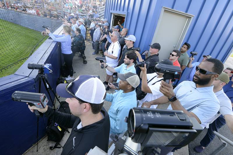 Dozens of baseball scouts gather behind home plate to watch Oswego East pitchers Ashton Izzi and Noah Schultz throw during a varsity boys baseball game on Thursday, May12, 2022 at Oswego High School.