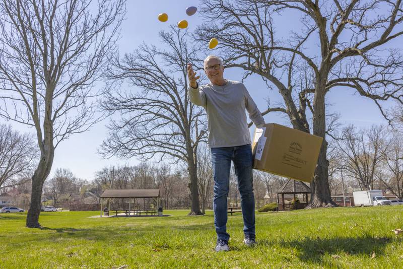 Event volunteer Ray Zborowski tosses out a handful of eggs prior to the second round of the Easter egg hunt on April 12, 2025 at Centennial Park in Peru.