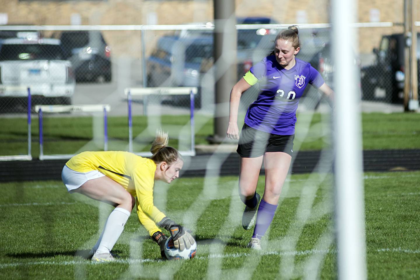 Dixon's Katie Drew crashes the net against the Stillman Valley goalkeeper Thursday, April 21, 2022.