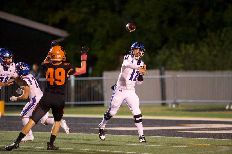 St. Charles North's Jesse Padron throws a pass for a gain against Wheaton Warrenville South on Friday, Oct. 10, 2025 in Wheaton.