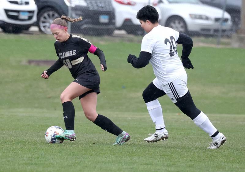 Sycamore's Taylor Zemanek pushes the ball ahead of La Salle-Peru's Adrianna Rodriguez during their game Wednesday, April 9, 2025, at Sycamore High School.