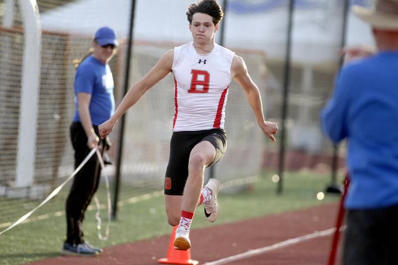 Batavia’s Alec Crum competes in the triple jump during the Kane County Championships track and field meet at St. Charles North on Friday, May 5, 2023.
