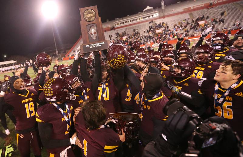 Members of the Montini Catholic football team hoist the Class 3A State football championship trophy on Friday, Nov. 29, 2024 at Hancock Stadium in Normal.