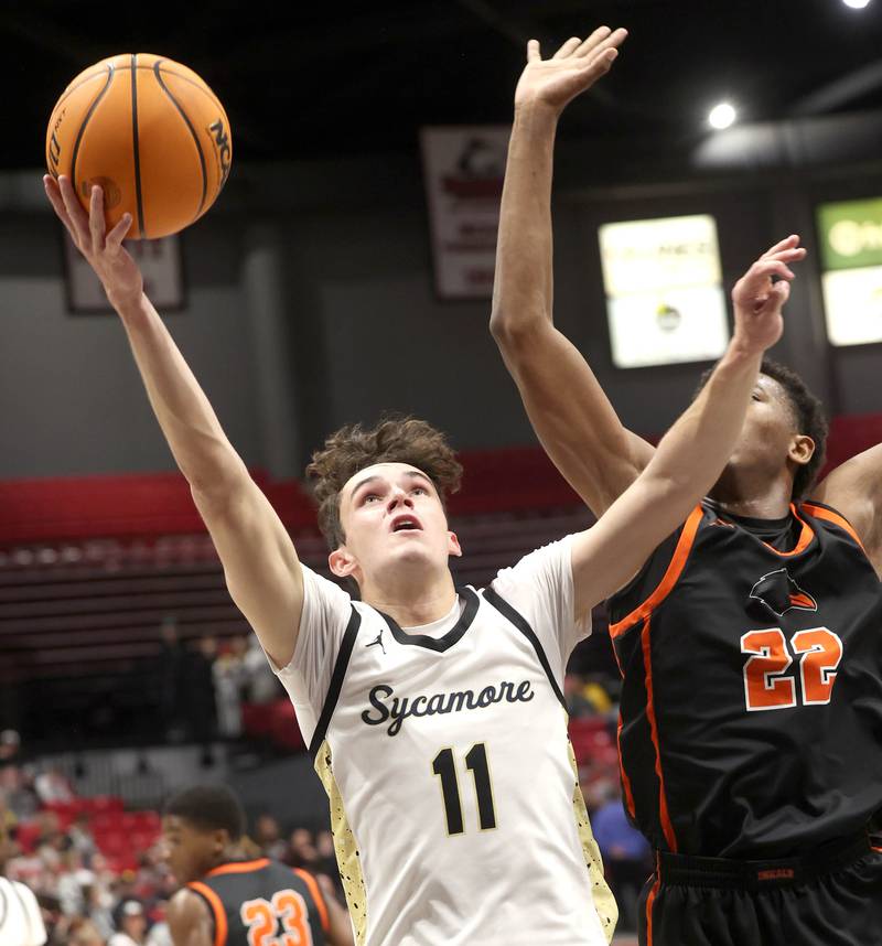 Sycamore's Jake Shipley shoots in front of DeKalb's Justin O’Neal during their game Friday, Jan. 31, 2025, in the FNBO Challenge in the Convocation Center at Northern Illinois University in DeKalb.