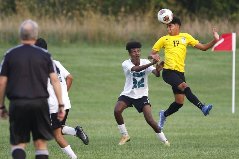 Harvard's David Aquino connects with a header infront of Woodstock North's Nibret Freundl takes on Woodstock North during their soccer game at Harvard Junior High School on Monday, Sept. 13, 2021 in Harvard.