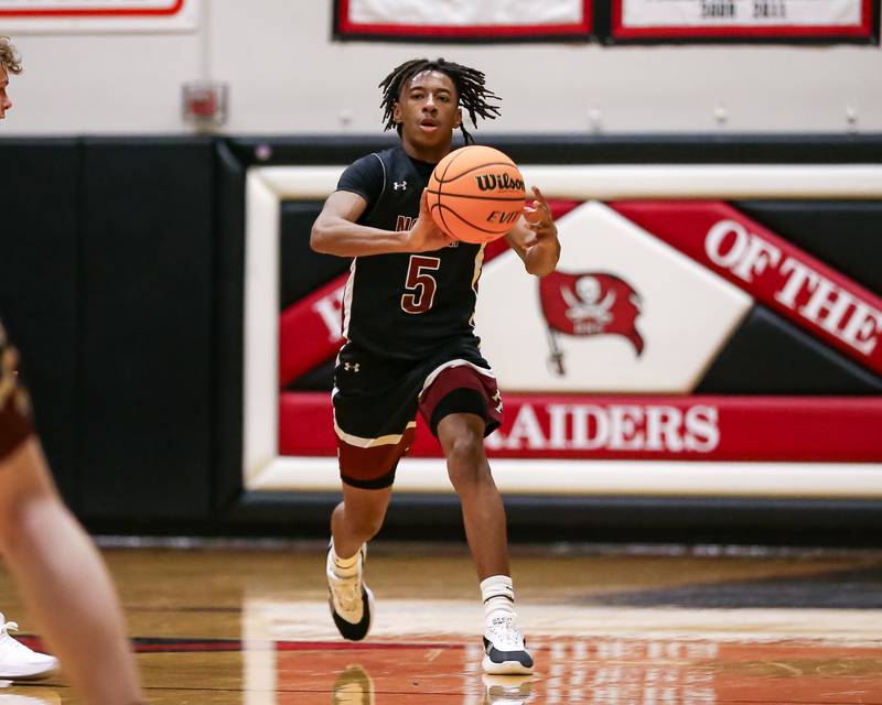 Plainfield North's Darin Ashiru (5) passes from halfcourt during their basketball game between Plainfield North at Bolingbrook, Friday Dec 13, 2024 in Bolingbrook.