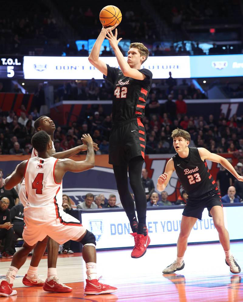 Benet’s Colin Stack shoots over a pair of Marist defenders Saturday, March 14, 2026, during their IHSA Class 4A state championship game in the State Farm Center at the University of Illinois in Champaign.