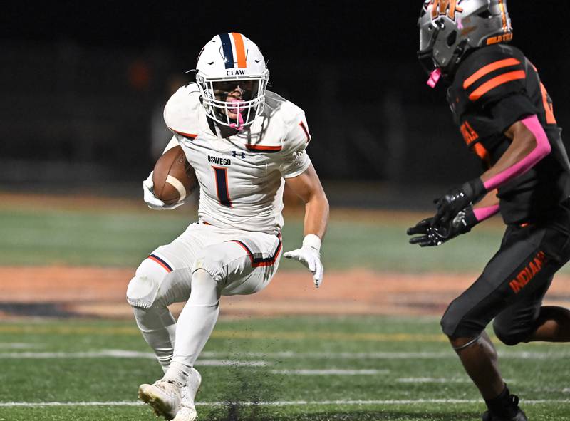 Oswego's Teddy (Theodore) Manikas (1) tries to elude a defender during the conference game against Minooka on Friday, OCT. 10, 2025, at Minooka.