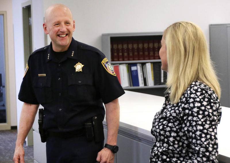 Retiring DeKalb Police Chief Gene Lowery shares a laugh with Detective Kelly Sullivan and other officers in the investigations wing of the department Friday May 17. Lowery's last day on the job will be May 31.