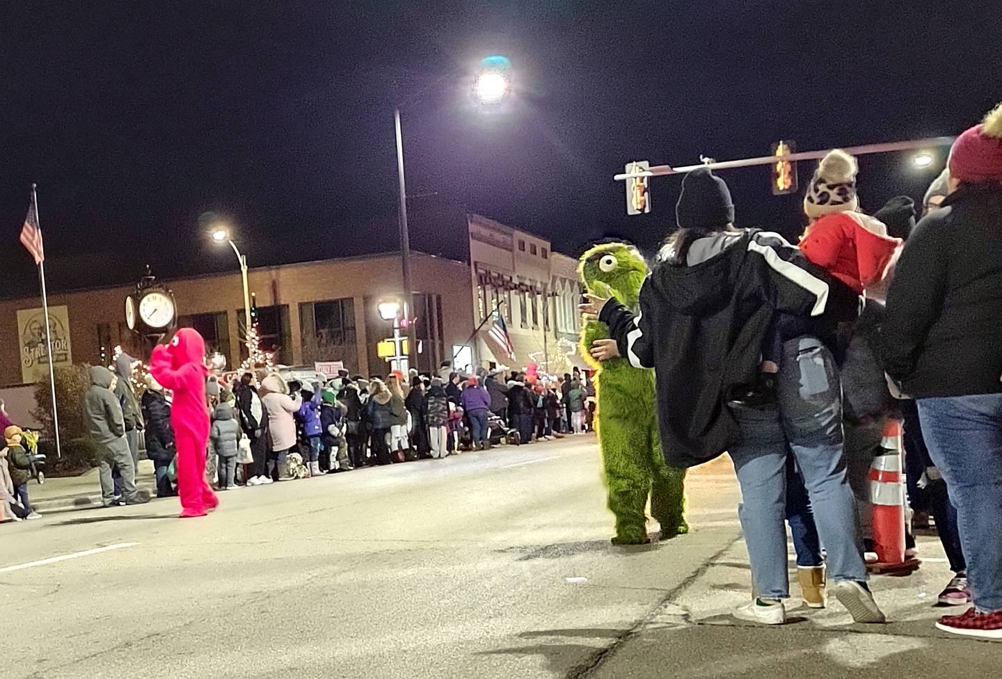 Elmo and Oscar the Grouch from Sesame Street greet lighted parade goers Saturday, Nov. 27, 2021, during Streator's Keeping Christmas Close to Home celebration.