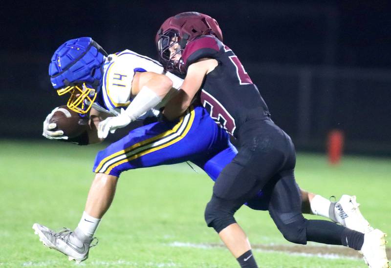 Marengo’s Hunter Muench, right, brings down Johnsburg’s Jackson Hjorth in varsity football at Rod Poppe Field on the campus of Marengo High School in Marengo on Friday, Oct. 3, 2025.