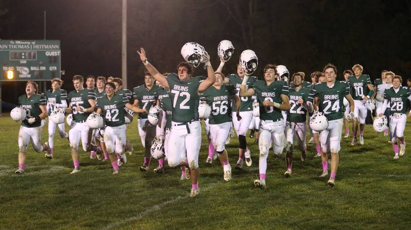 Members of the St. Bede Bruin footbal team celebrate their victory over Ottawa on Friday, Oct. 25, 2024 at St. Bede Academy.