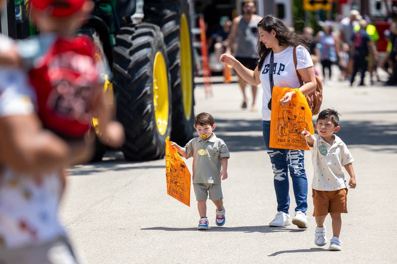 Family walks down 13th street at the Touch a Truck event on Saturday, June 28, 2025 at Centennial Park in Peru.