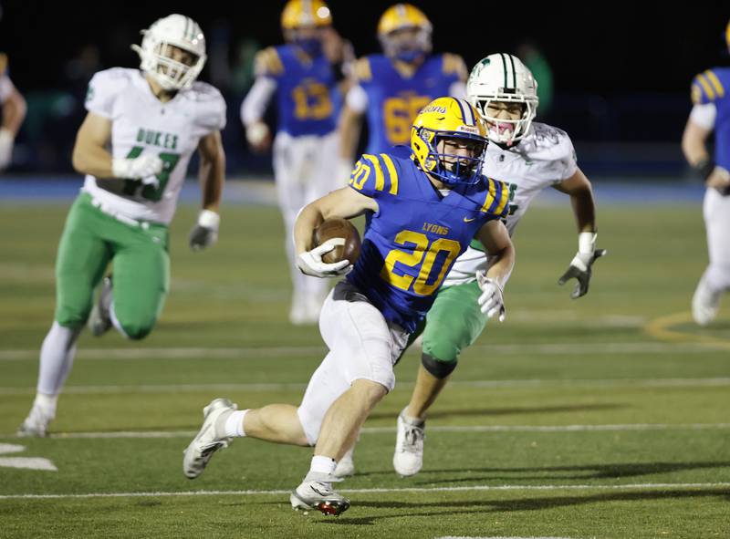 Lyons' EJ Kuhlman (20) runs the ball during the varsity football first-round 8A playoff game between York and Lyons Township on Friday, Oct. 31, 2025 in Western Springs, IL.
