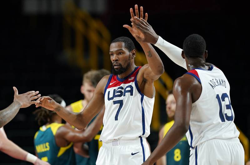 United States's Kevin Durant (7) celebrates with teammates after scoring during men's basketball semifinal game against Australia at the 2020 Summer Olympics, Thursday, Aug. 5, 2021, in Saitama, Japan.