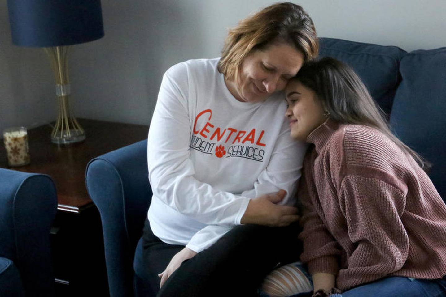 Meydi Guzman rests her head on the shoulder of her school counselor, Sara Huser, on Friday, Feb. 28, 2020 in Crystal Lake.   Guzman, who was recently released from ICE detention, is staying temporarily with Huser, who fought to have her released.