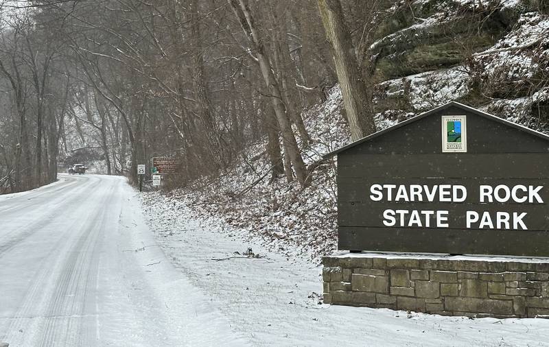 A motorist enters Starved Rock State Park as snow covers the main entrance roadway on Wednesday, Feb. 12, 2025 near Utica.