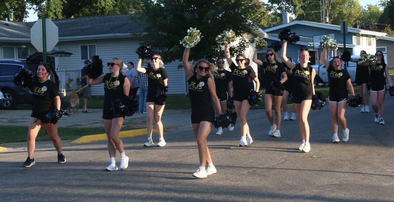 Putnam County High School cheerleaders march during the inaugural Homecoming parade on Wednesday, Sept. 17, 2025 down Elm Street in Granville.