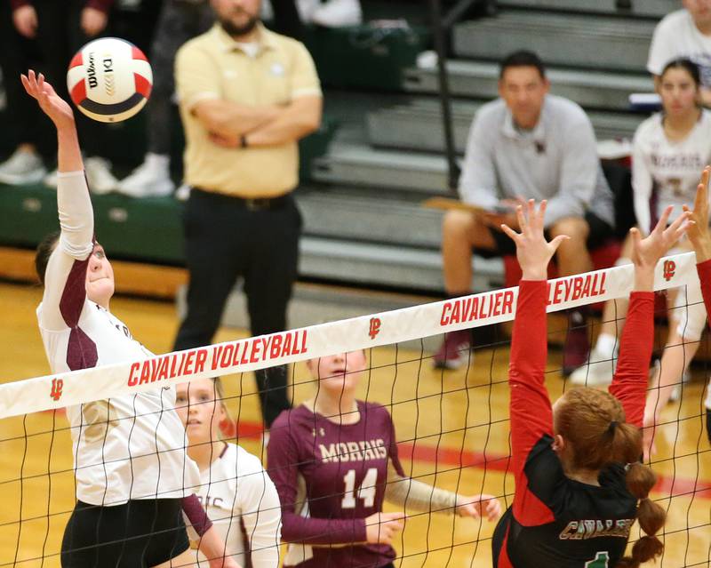 Morris's Aubrey Phillips spikes the ball past L-P's Addison Duttlinger in the Class 3A Regional game on Thursday, Oct. 26, 2023 at Sellett Gymnasium.