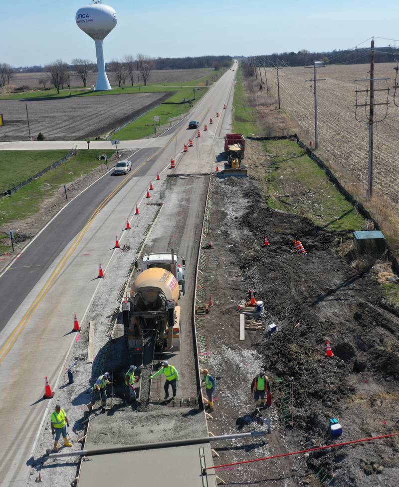 Workers pour a large section on the south side of the roundabout at the intersection of Route 71 and Illinois 178 on Tuesday, April 11, 2023 in Utica.