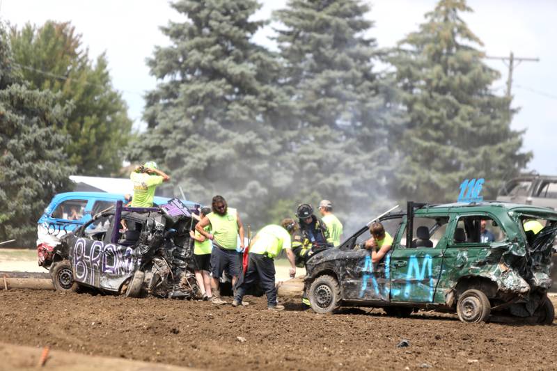 Drivers watch as a St. Charles firefighter uses an extinquisher on their cars as the demoltion derby comes to an end during the 155th Kane County Fair in St. Charles on Sunday, July 21, 2024.