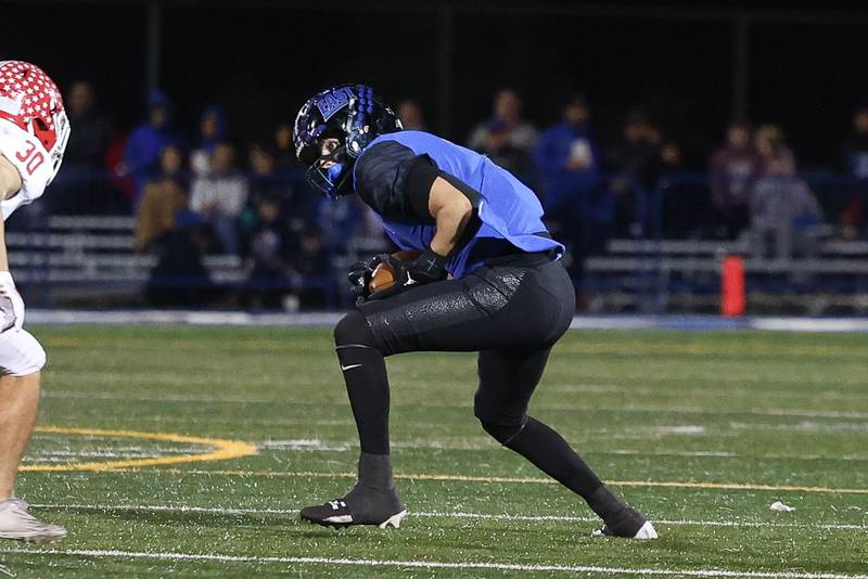 Lincoln-Way East’s Trey Zvonar cuts upfield after a catch against Naperville Central on Friday, Oct. 25, 2024 in Frankfort.
