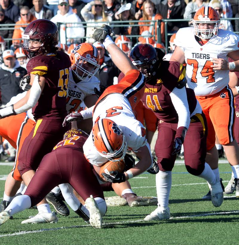 Byron's Caden Considine (37) is knocked off his feet as he runs for a gain against Lombard-Montini  in 3A football semifinal action in Lombard on Saturday, Nov. 18, 2023.