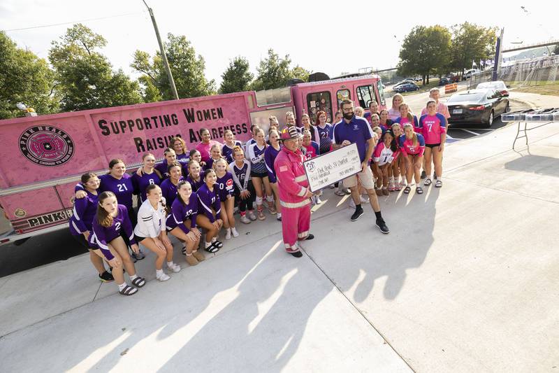 Dixon High School’s volleyball teams pose for a picture in front of the Pink Heals of the Sauk Valley firetruck Thursday, Oct. 2, 2025. In recognition of Breast Cancer Awareness Month, the teams raised money through donations and sales to donate $500 to Pink Heals and also a donation to a community member battling cancer.